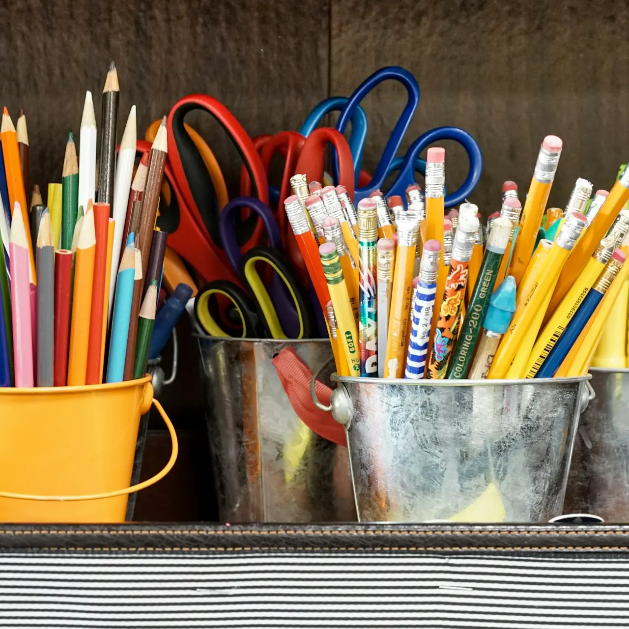 assorted color pencils in yellow bucket